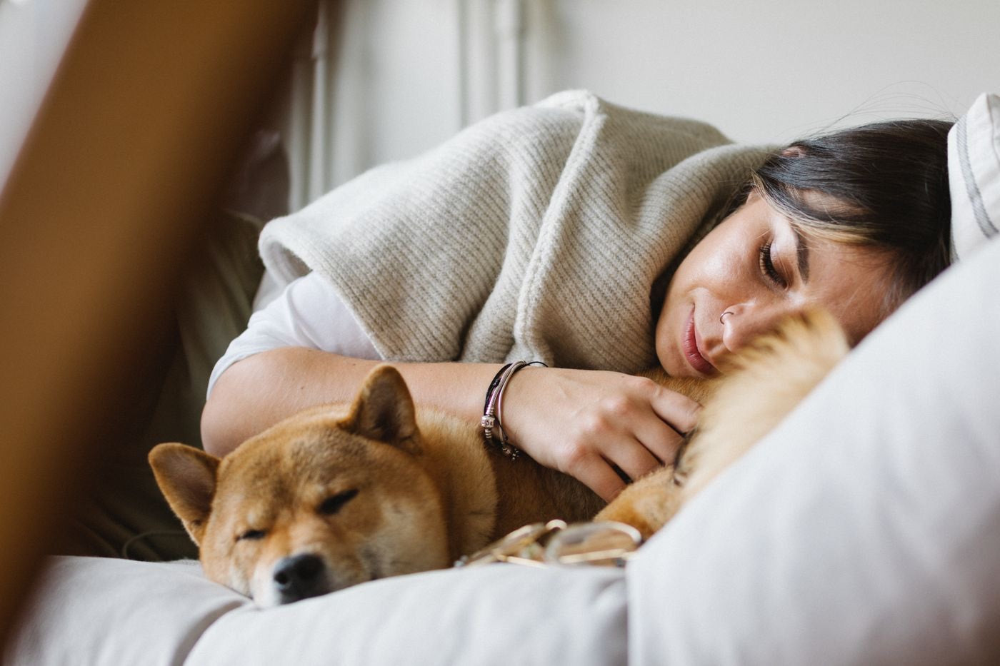 An owner relaxing peacefully at home with her calm, quiet dog
